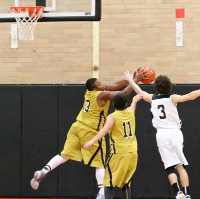 Image: Darol Mayberry(13) crashes the boards to secure a rebound.