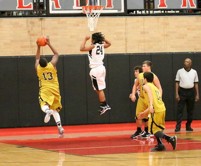 Image: Darol Mayberry(13) outthinks a Zebra for another rebound.