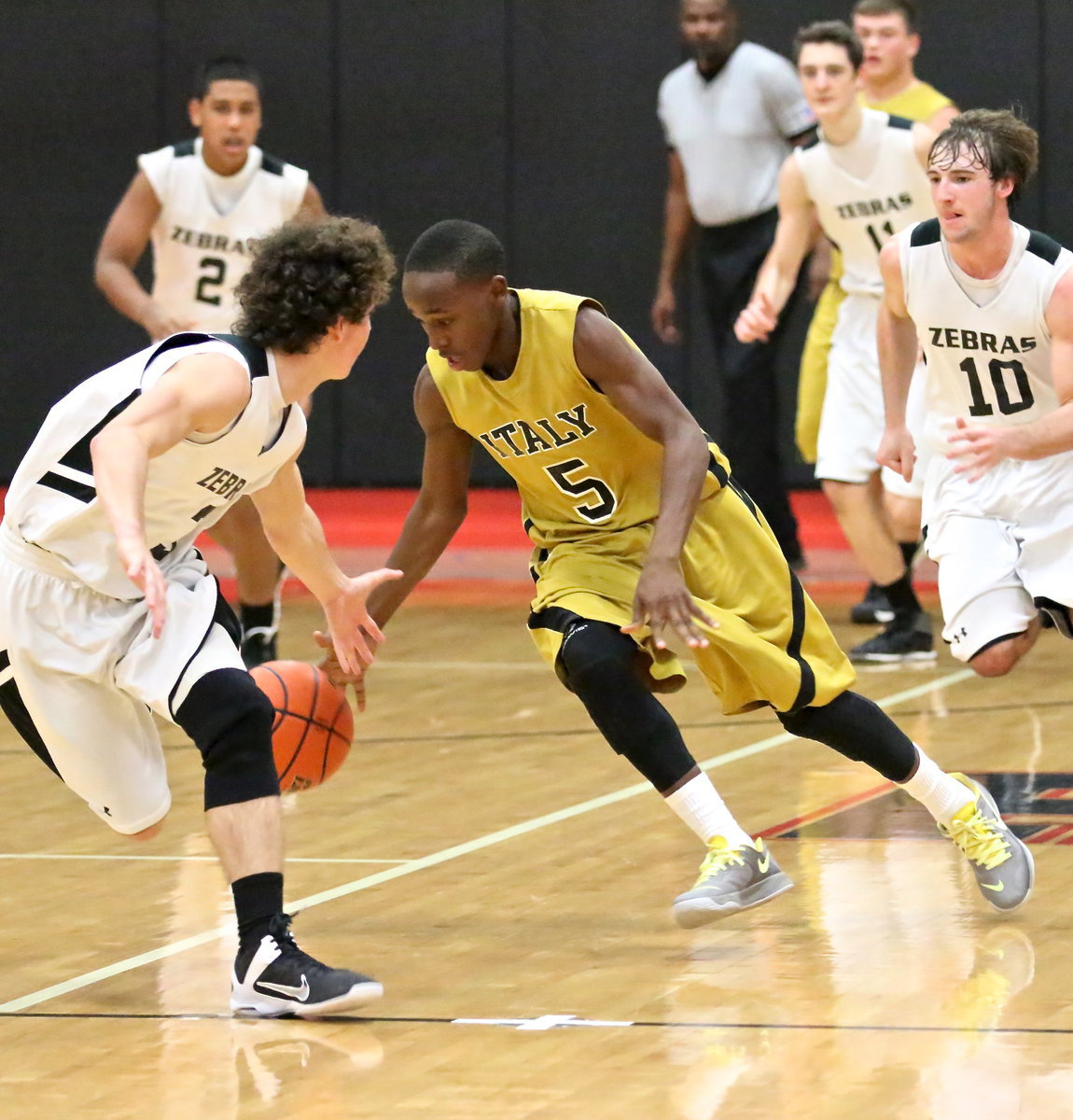 Image: Kevin Johnson(5) helps push the ball forward for the gold.