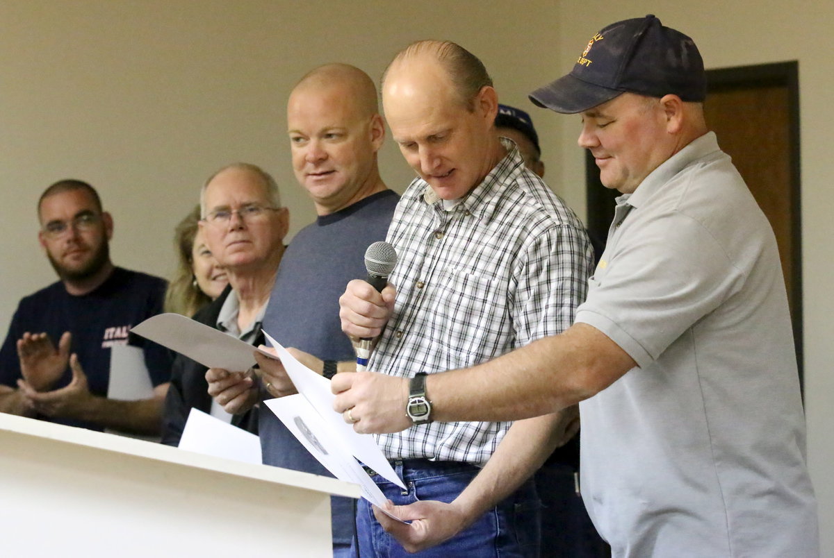 Image: Randy Boyd does his best Jackie Cate impersonation and presents Cate with his service certificate.