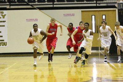 Image: Kenneth Norwood(5) pushes the ball as teammates Eric Carson(2), Jacob Brooks(12) and Michael Moore(4) head up court.