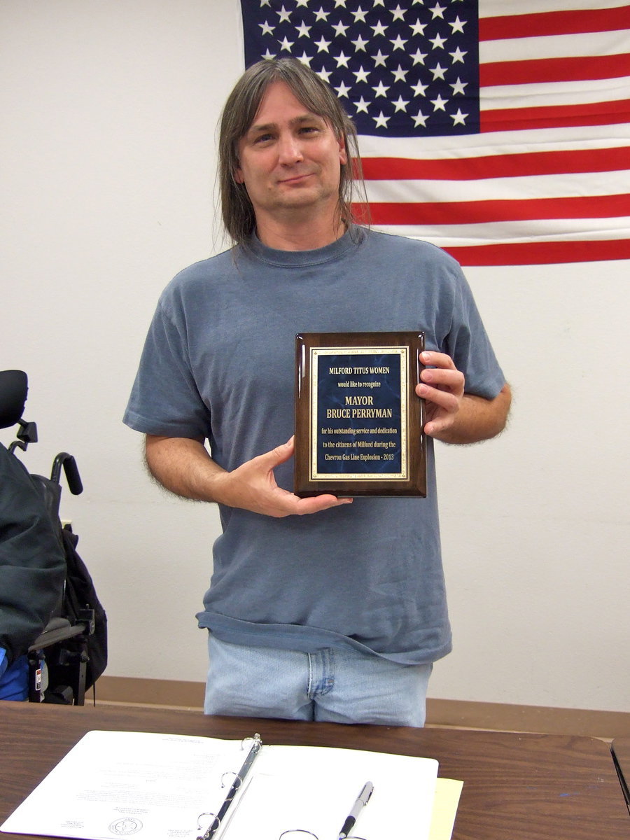 Image: Perryman shows off his plaque proudly.