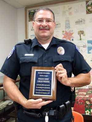 Image: Chief Phoenix holds up his plaque for all to see.