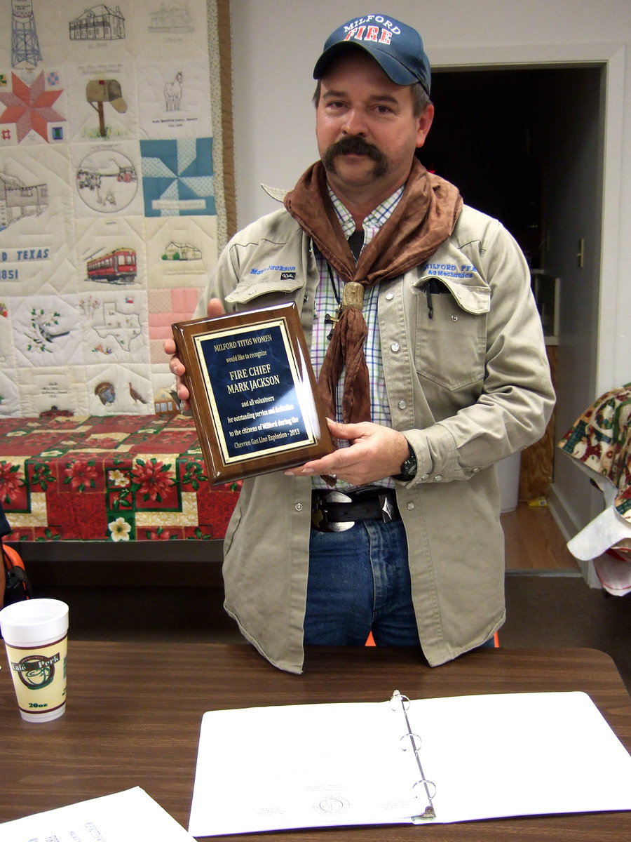 Image: Fire Chief Jackson holds up his plaque proudly.