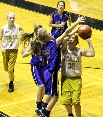 Image: Italy 7th grader Hannah Haight(32) takes a hand to the face while powering up for a shot.  They had to shut her down after Haight scored 2-points earlier in the contest.