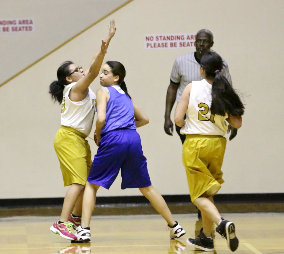 Image: Karla Perez(30) closes out on a Blooming Grove jump shooter as teammate Emily Guzman(21) moves in to trap the ball.