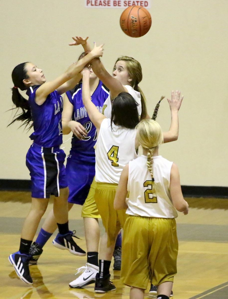 Image: Hannah Haight(32), Madison Galvan(4) and Karson Holley(2) converge on a Blooming Grove shooter with Haight denying the shot attempt.