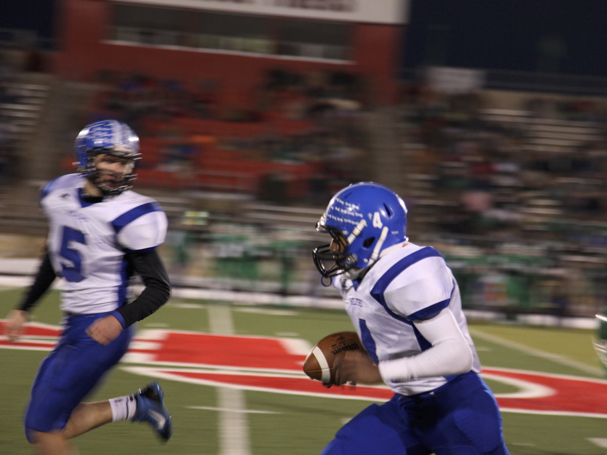 Image: Senior Eric Evans, quarterback, makes way for senior Jacobe Essary to run the ball for a touch down!