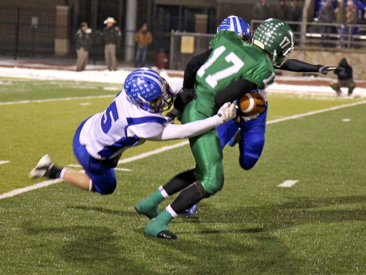 Image: Eric Evans knocks a Bobcat to the ground.