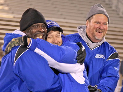 Image: Emotional moment for coaches Otis Carter, Joe Stephens and Ronny Crumpton after the Bulldog win.