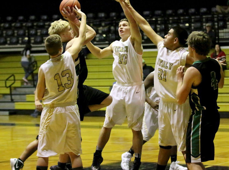 Image: James Walton(13), Coby Bland(10) and David De la Hoya(21) team up to block a Rio Vista shooter during JV action.