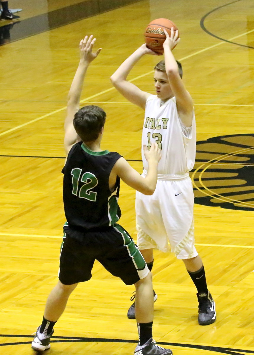 Image: James Walton(13) tries to spot an open teammate with an Eagle claw in his face.