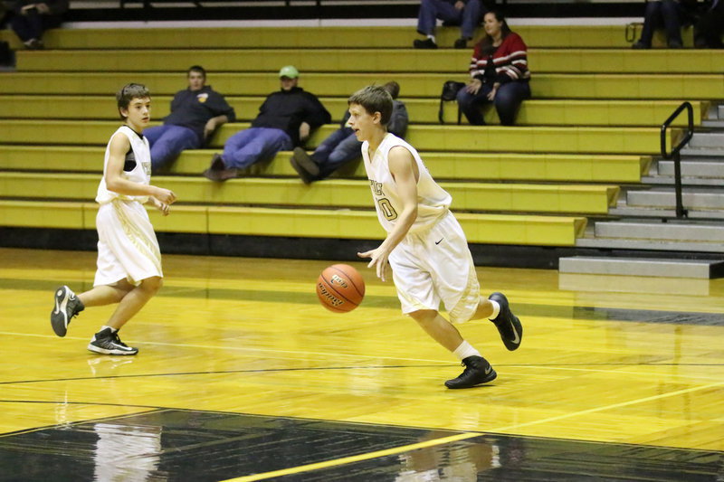 Image: Joshua Cryer gets a handle on the ball as he and teammate Dylan McCasland transition from defense to offense.