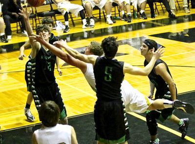Image: Bailey Walton(14) goes up and under to get the bucket.