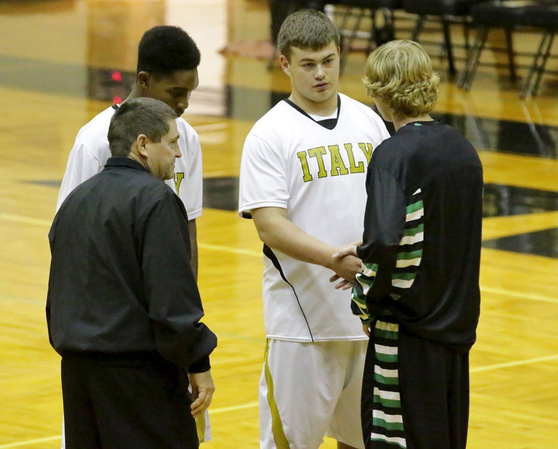 Image: Senior captains Tre Robertson(93) and Zain Byers(50) represent Italy at center court to welcome Rio Vista’s captain to Italy Coliseum. Referee Don Garrison oversees the exchange.