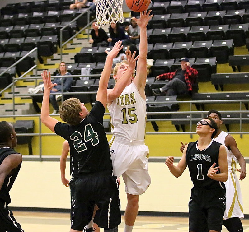 Image: Cody Boyd(15) leaps high to bank in a shot.