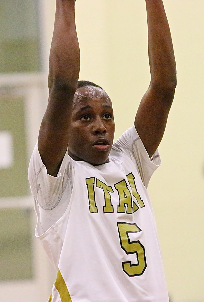 Image: Kevin Johnson(5) eyes the basket during his free-throw.