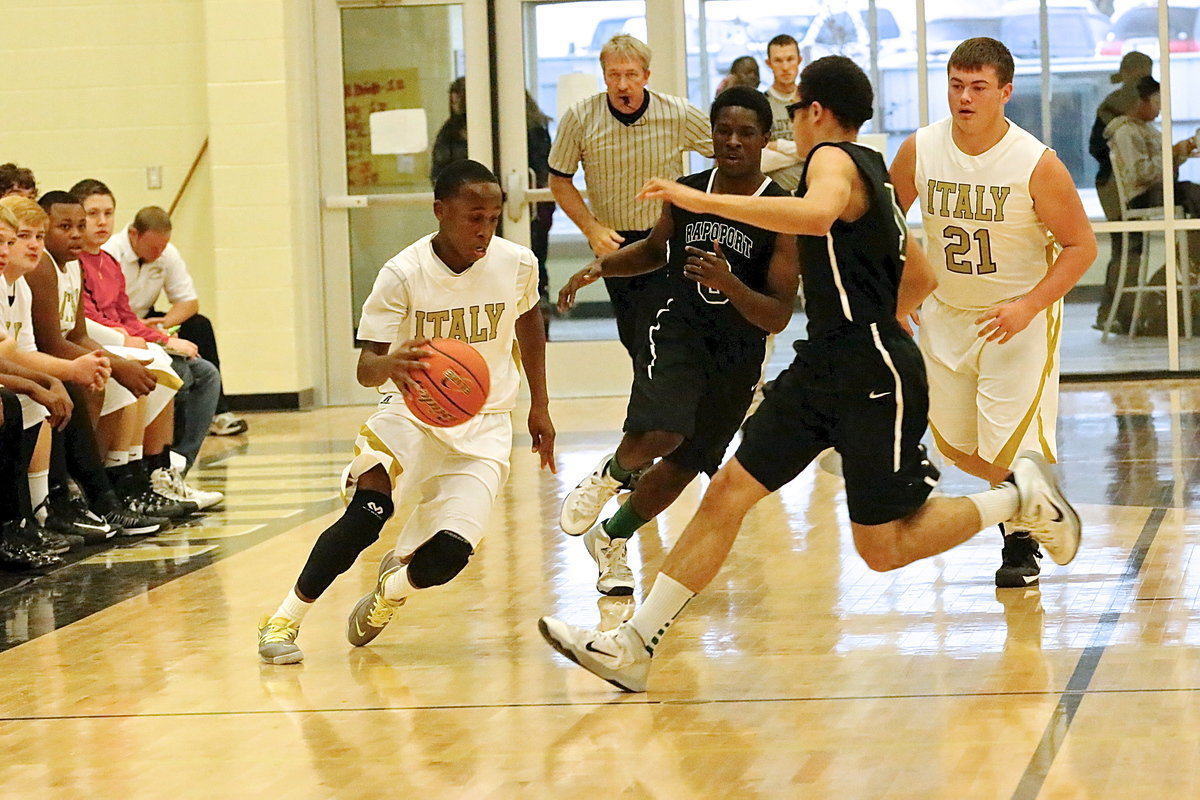 Image: Kevin Johnson(5) crosses over between two Rappaport defenders.