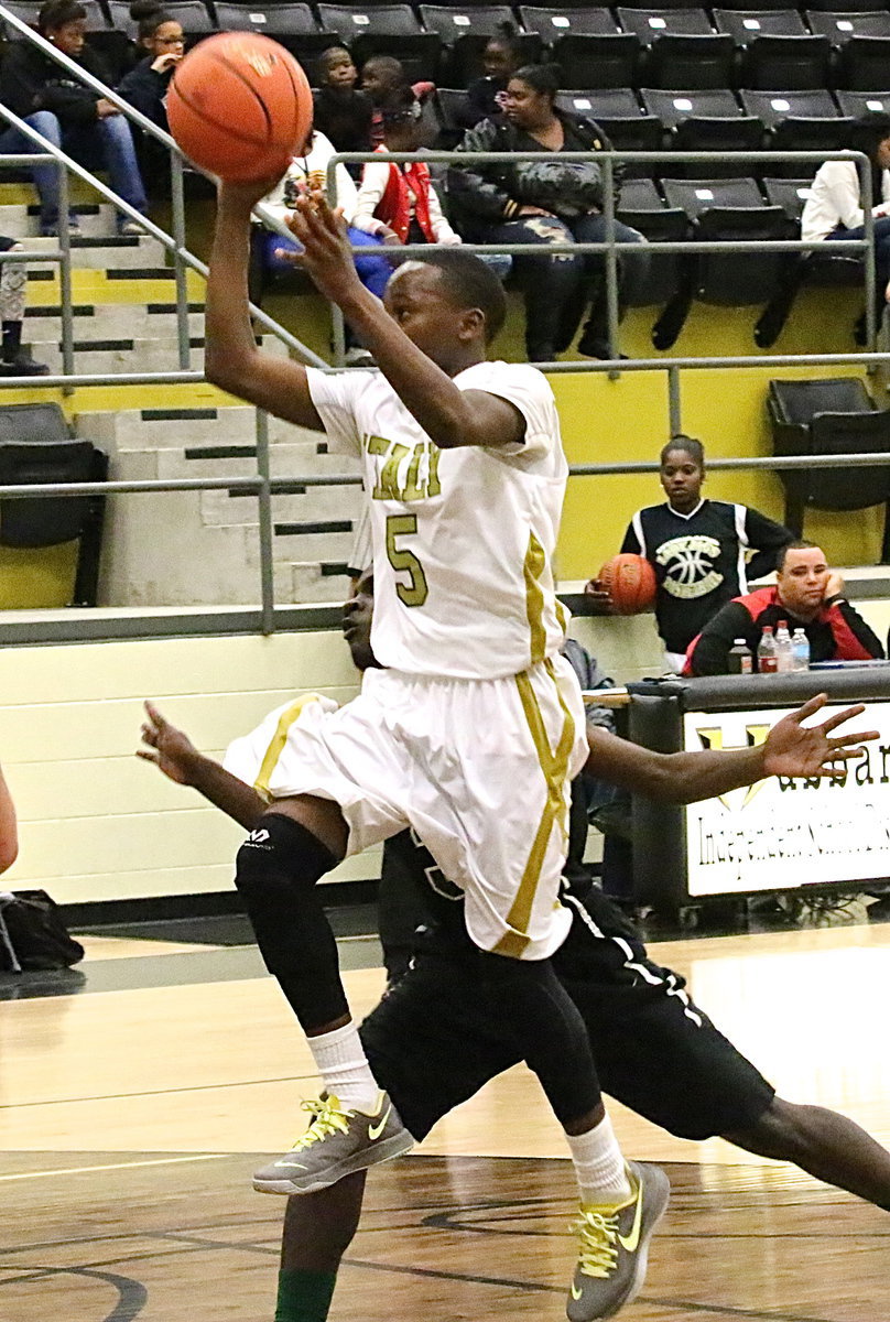 Image: Kevin Johnson(5) dribbles and then lofts up a shot.