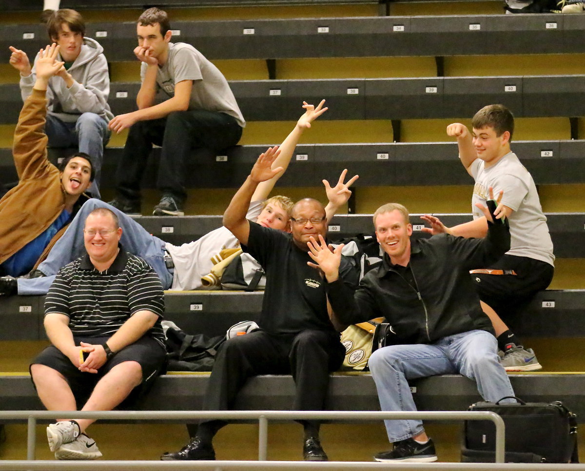 Image: Gladiator coaches Brandon Ganske, Larry Mayberry, Sr., and Jon Cady chill with their varsity players Ty, Ryan, Mason, Cody and Zain before their game against Bynum.