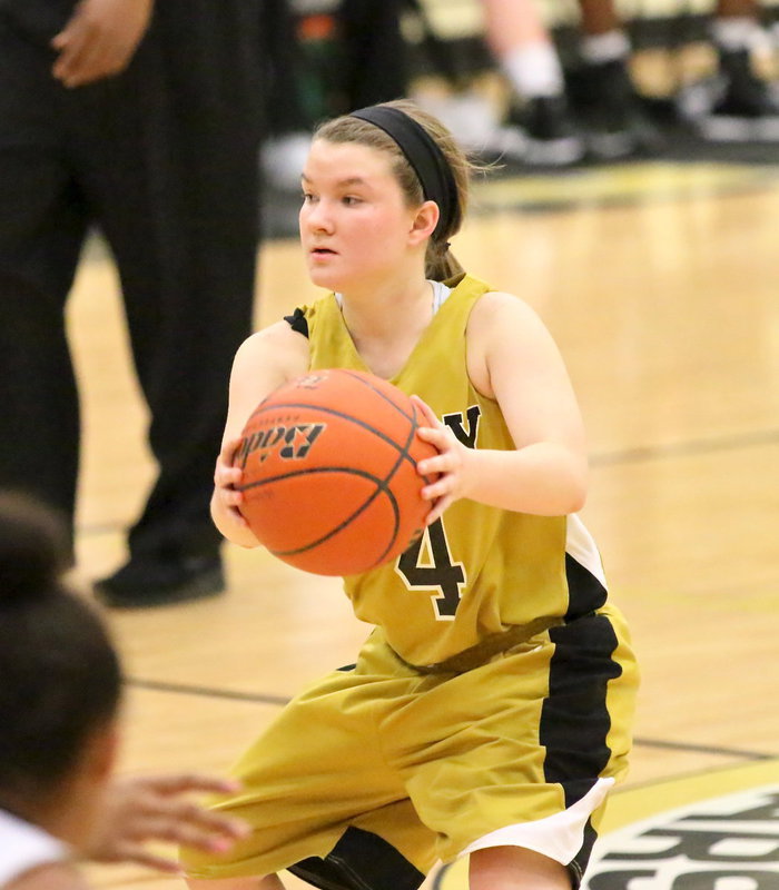 Image: Tara Wallis(4) swings the ball around the horn on offense.