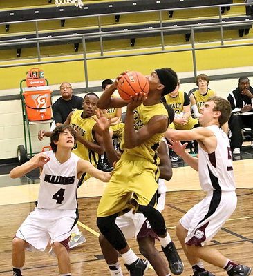 Image: Trevon Robertson(2) attacks the basket.