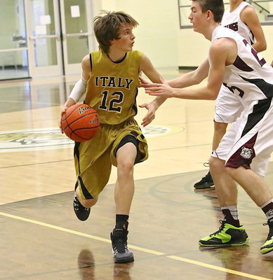 Image: Ty Windham(12) keeps his dribble alive.