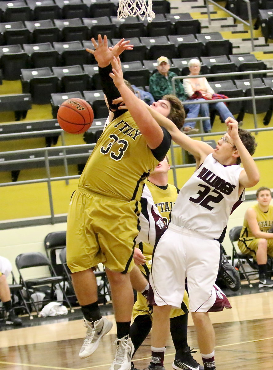 Image: Kevin Roldan(33) is fouled under the basket.