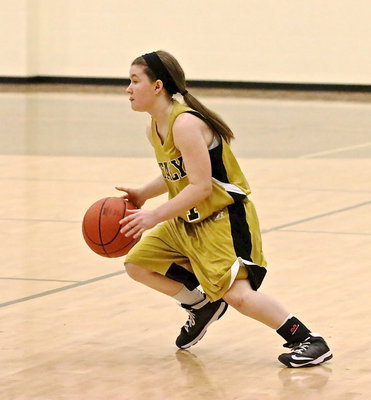 Image: Tara Wallis(4) pushes the ball up the floor.