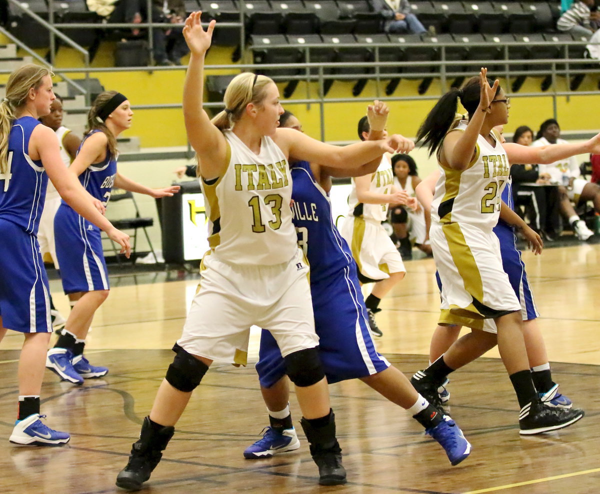 Image: Jaclynn Lewis(13) posts up on the block while teammate Oleshia Anderson(24) calls for the ball from the elbow.