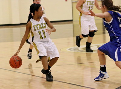 Image: Ryisha Copeland(11) works the ball up the court while keeping the ball away from Bosqueville hands.