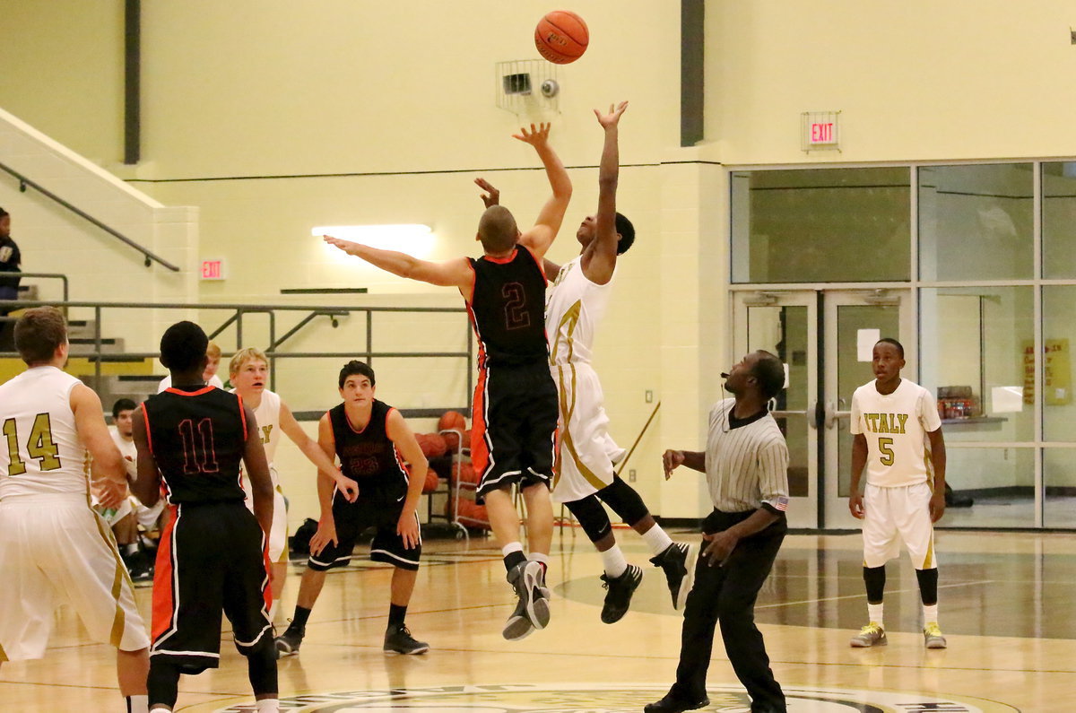 Image: Trevon Robertson(2) tries for the jump ball to start the action.