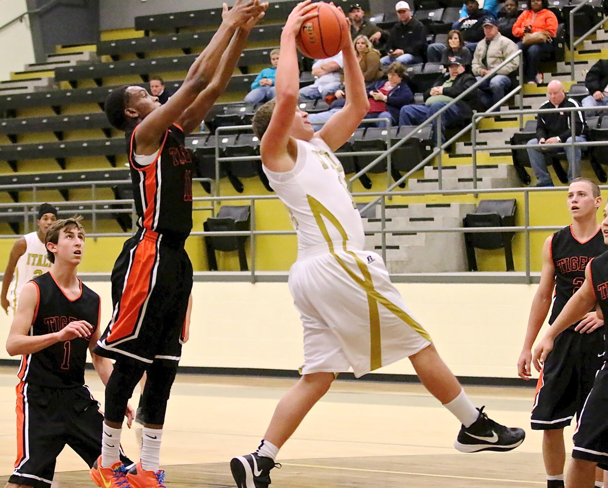 Image: Bailey Walton(14) grabs an offensive rebound and then goes back up for the shot.