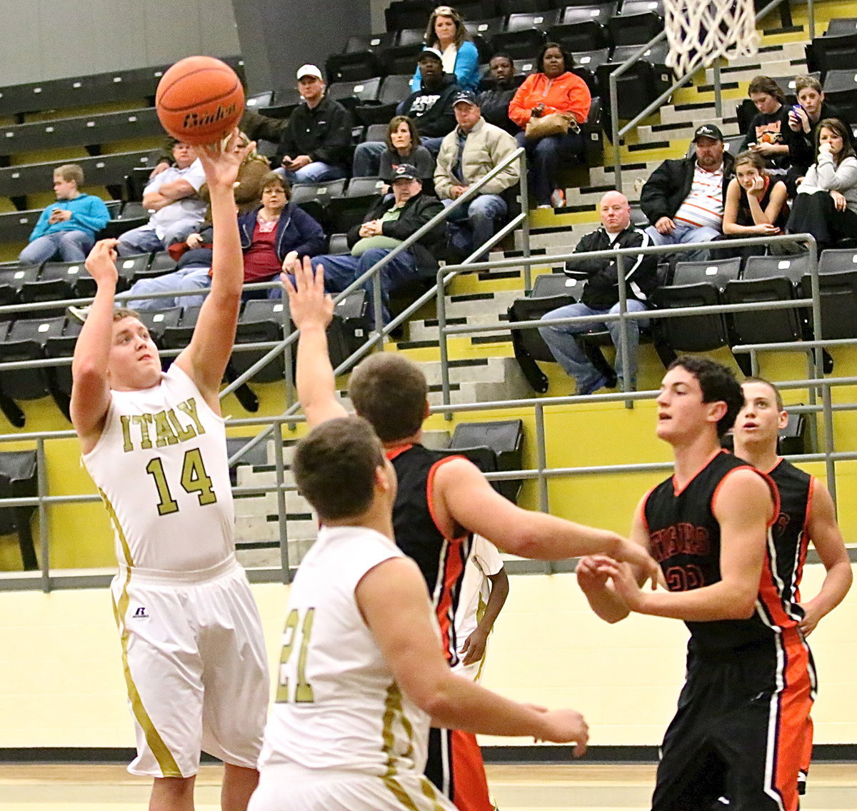 Image: Bailey Walton(14) takes a shot over a Tiger paw.