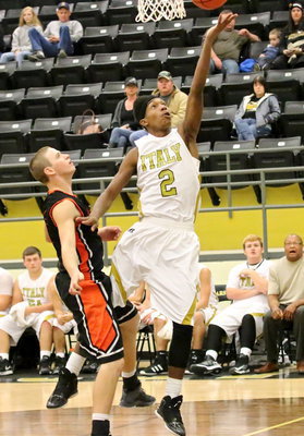 Image: Trevon Robertson(2) fends off a Tiger defender while laying in a basket.
