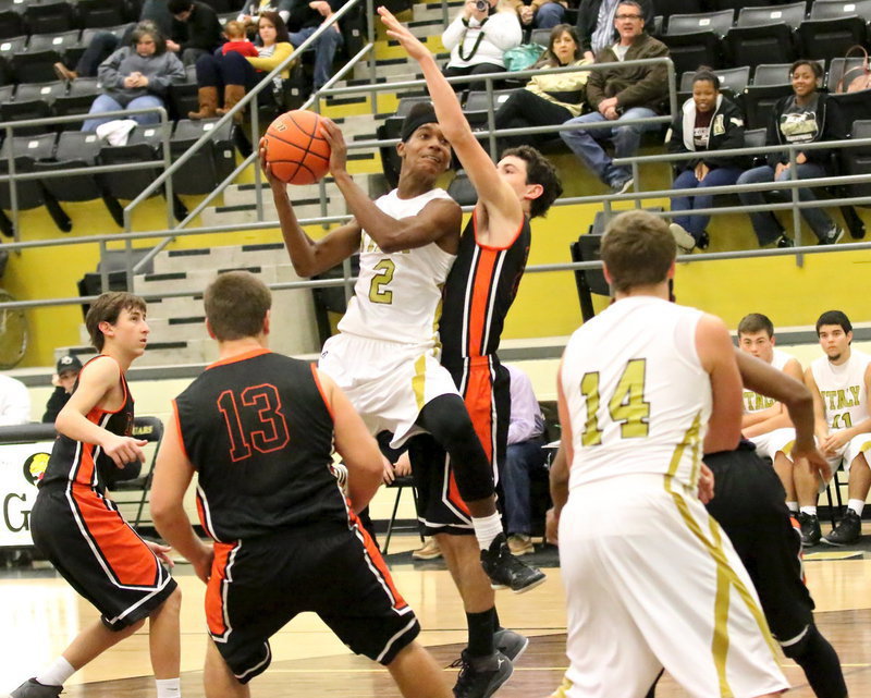 Image: Italy’s Trevon Robertson(2) crashes into the lane to put up a shot against Centerville.
