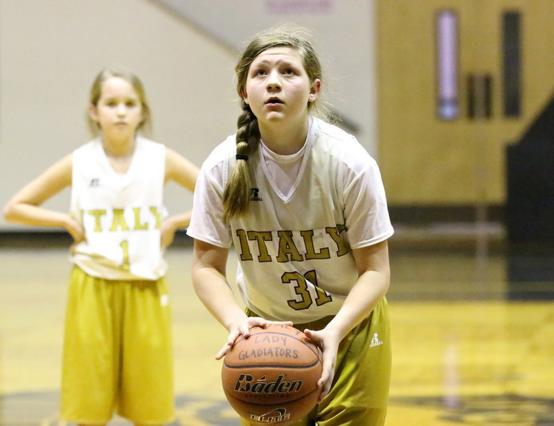 Image: In the 7th grade girls game versus Venus, Tatum Adams(31) concentrates while trying her luck from the line.