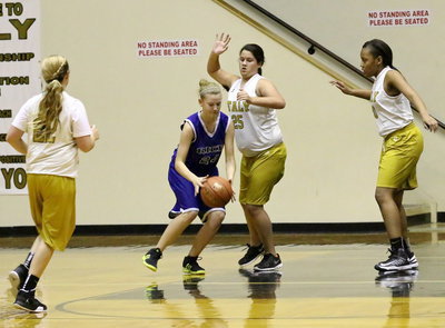 Image: Jenna Holden(25), Brycelen Richards(22) and Charisma Anderson(20) close in on the ball.