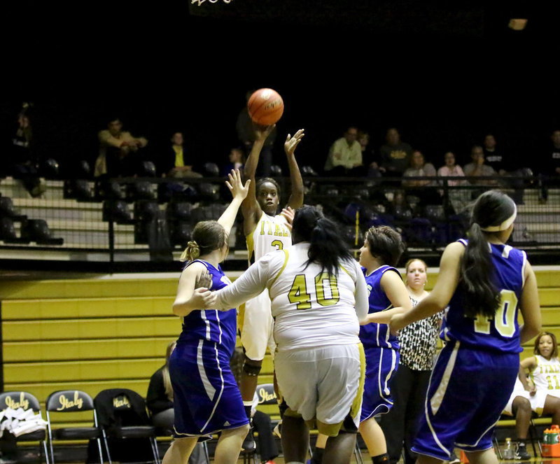 Image: Kortnei Johnson(3) takes a jumper with teammate Cory Chance(40) deflecting Venus defenders away.