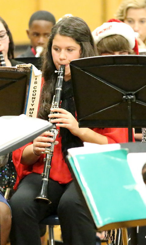 Image: Jenna Holden brings Christmas spirit to the old Italy gym via her clarinet.