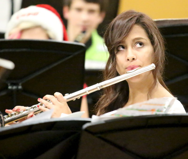 Image: Ana Luna keeps her eyes on the beat while playing the flute.