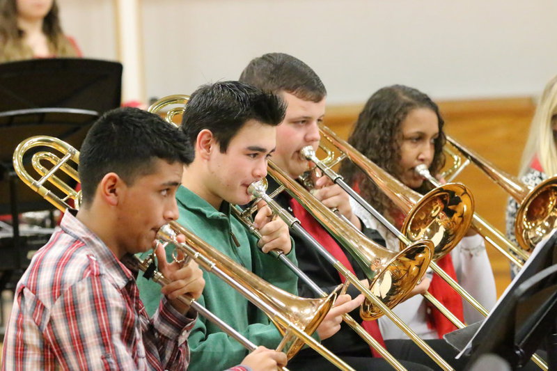 Image: Jorge Galvan, Kyle Tindol, Zac Mercer and Emmy Cunningham play their trombones during the Christmas concert.