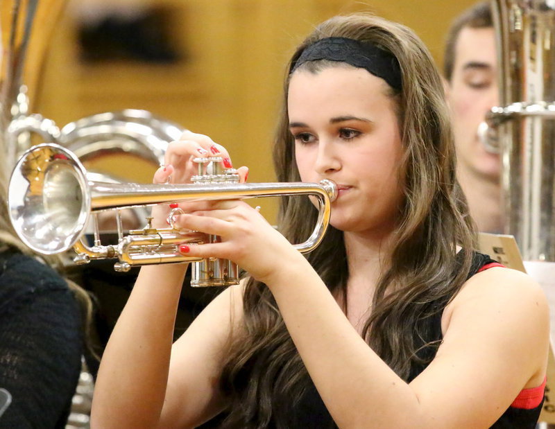 Image: Amber Hooker uses her trumpet to set the mood for the holidays.