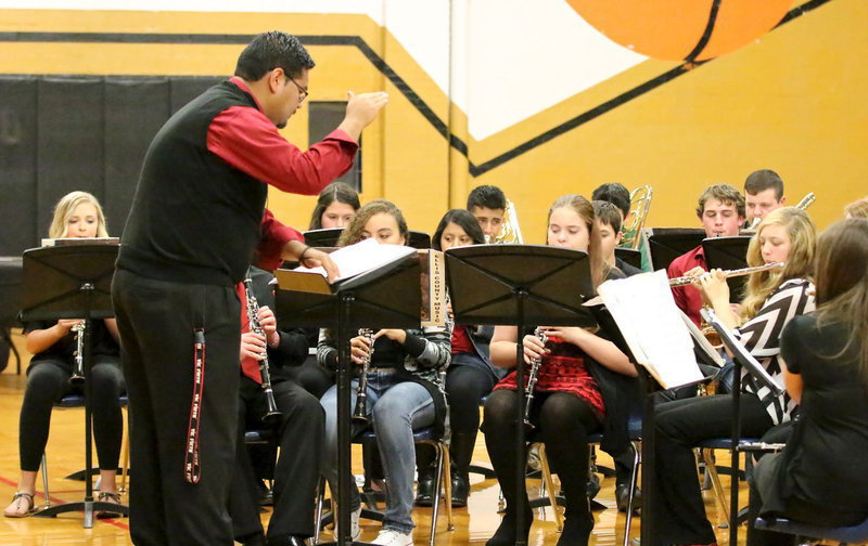 Image: Italy HS band director Jesus Perez directs Gladiator Regiment Band members thru a Christmas melody.