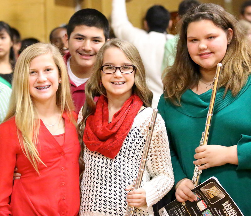 Image: Karson Holley, Alex Garcia, Karley Neslon and Virginia Stephens are proud of the Jr. High Band’s holiday presentation.