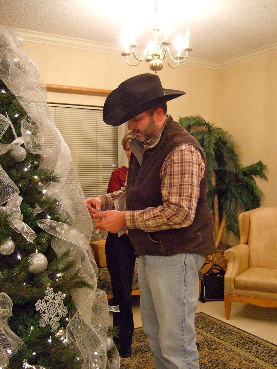 Image: Greg Adams remembering his father Clayton Adams as he puts his angel on the tree of memories.