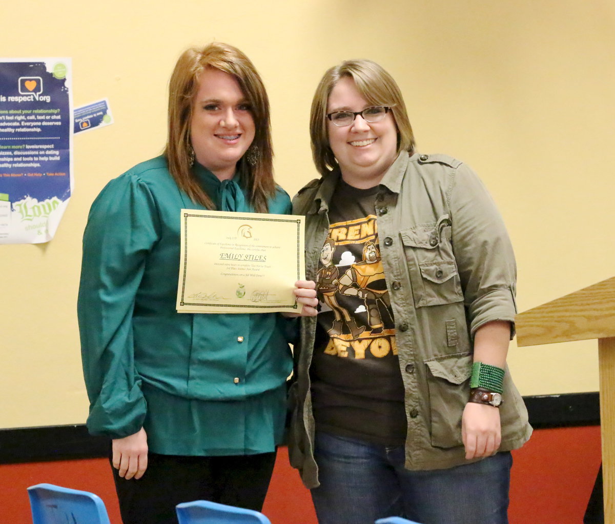 Image: With the school board observing, senior Emily Stiles is presented her certificate of achievement from Catherine Hewitt for her 3rd place finish in the science fair.