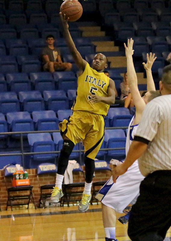 Image: Kevin Johnson(5) gets to the basket for a layup.