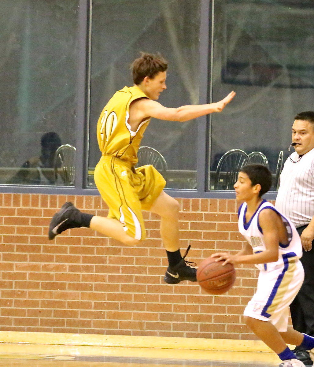 Image: Joshua Cryer(20) screams thru the air to scare Venus away from trying a 3-pointer.