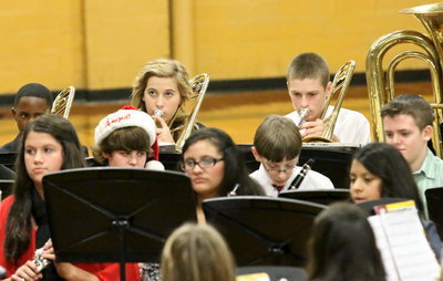 Image: Jaylon Lusk, Hannah Haight and Clay Riddle play trombone for the junior high band.